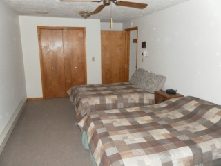 Lower level bedroom with three double beds.